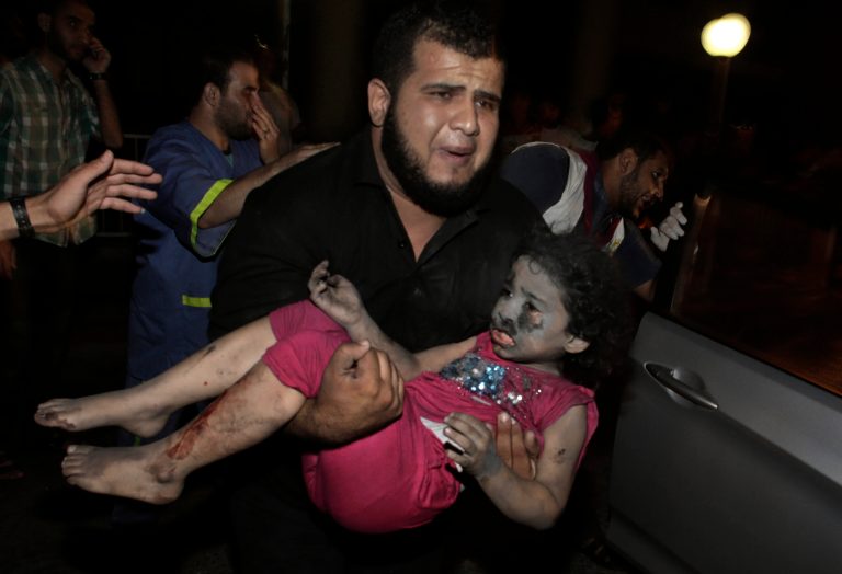 A Palestinian man carries an injured girl into the Shifa hospital following Israeli strikes which hit Gaza City, Tuesday, Aug. 19, 2014. Israel resumed its campaign of airstrikes in Gaza on Tuesday in response to a barrage of Palestinian rocket fire that shattered a truce. The sudden burst of fighting has threatened to derail an Egyptian effort to end a monthlong war between Israel and Hamas militants in Gaza. (AP Photo/Khalil Hamra)
