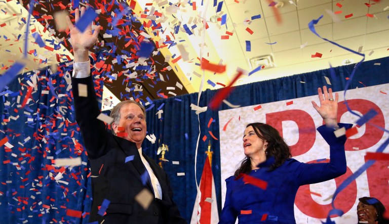 Democratic candidate for U.S. Senate Doug Jones and his wife Louise wave to supporters before speaking Tuesday, Dec. 12, 2017, in Birmingham, Ala. Jones has defeated Republican Roy Moore, a one-time GOP pariah who was embraced by the Republican Party and the president even after facing allegations of sexual impropriety. (AP Photo/John Bazemore)