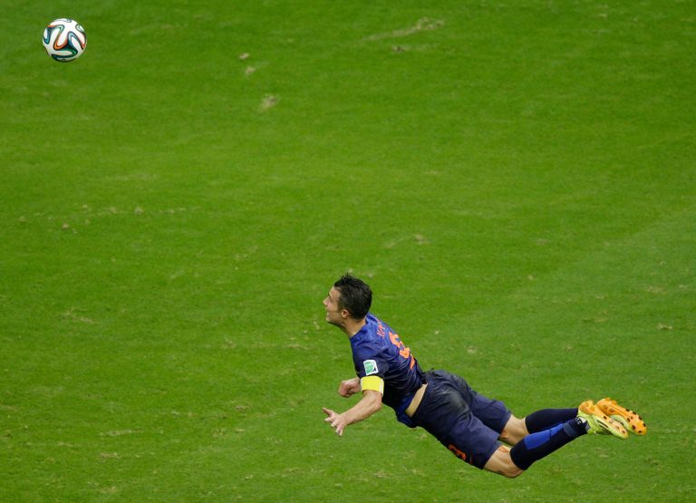 In this Friday, June 13, 2014 photo, Netherlands' Robin van Persie heads the ball to score during the group B World Cup soccer match between Spain and the Netherlands at the Arena Ponte Nova in Salvador, Brazil. The Dutchman's header that looped over a stranded Iker Casillas in the Spain goal was not only very special but historic. By taking his tally to 45 goals for his country, the Manchester United forward also became the first Dutch player to score in three consecutive World Cups. (AP Photo/Christophe Ena)