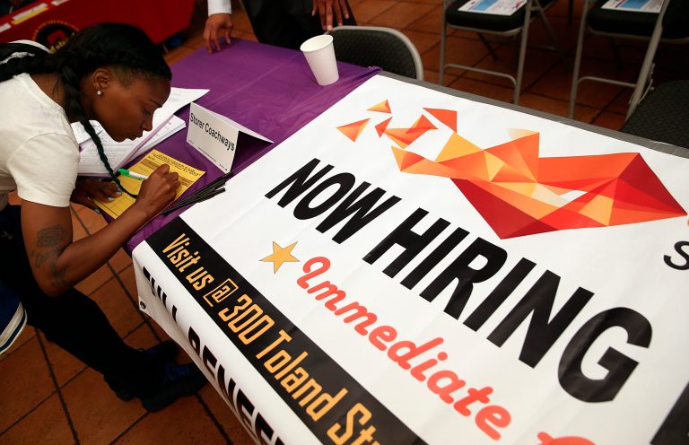 A job seeker fills out an application during a career fair at the Southeast Community Facility Commission on May 21, 2014 in San Francisco, California. (Photo by Justin Sullivan/Getty Images)