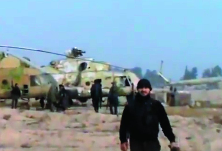 In this image taken from video obtained from the Ugarit News, which has been authenticated based on its contents and other AP reporting, Syrian rebels capture a helicopter air base near the capital Damascus after fierce fighting in Syria, on Sunday, Nov. 25, 2012. The takeover claim showed how rebels are advancing in the area of the capital, though they are badly outgunned by Assad's forces, making inroads where Assad's power was once unchallenged. Rebels have also been able to fire mortar rounds into Damascus recently. (AP Photo/Ugarit News via AP video)