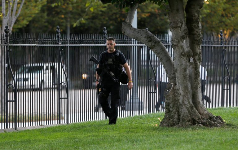 A member of security with a weapon walks along the interior of the perimeter fence on White House North Lawn along Pennsylvania Avenue in Washington, Monday, Sept. 22, 2014. The Secret Service tightened their guard outside the White House after Friday's embarrassing breach in the security of one of the most closely protected buildings in the world. A man is accused of scaling the White House perimeter fence, running across the lawn and entering the presidential mansion before agents stopped him. (AP Photo/Carolyn Kaster)
