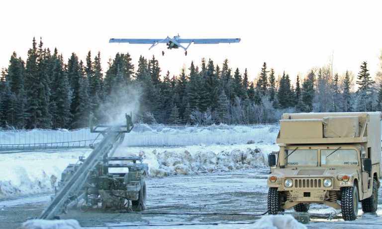 An RQ7 Shadow unmanned aircraft flies from its pneumatic catapult launcher at Joint Base Elmendorf Richardson in Anchorage, Alaska, on Thursday. (AP Photo/Dan Joling)