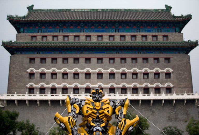 A replica model of the Transformers character Bumblebee stands in front of Qianmen Gate, as part of a promotion of the movie 