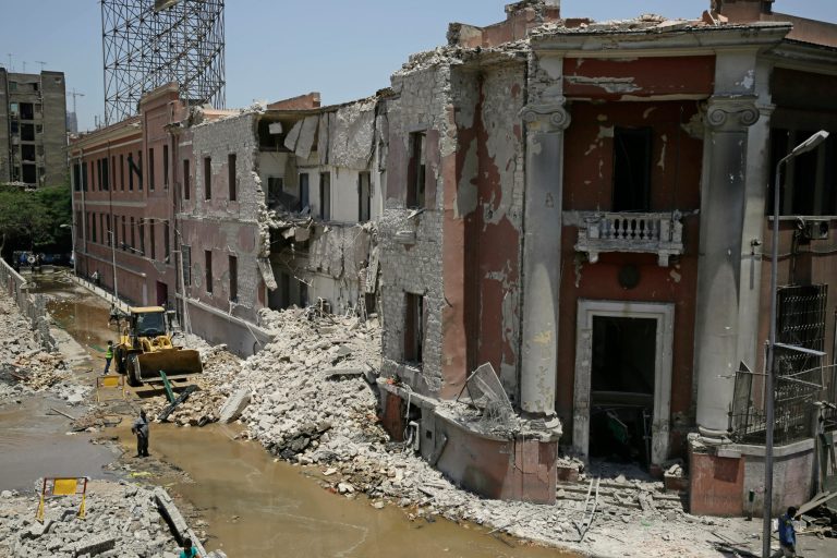 Workers clear rubble at the site of an explosion near the Italian Consulate in downtown, Cairo, Egypt, Saturday, July 11, 2015. Italy's foreign minister vowed that his country would not be intimidated after a deadly explosion Saturday morning killed one person and heavily damaged the Italian Consulate in the Egyptian capital. (AP Photo/Thomas Hartwell)