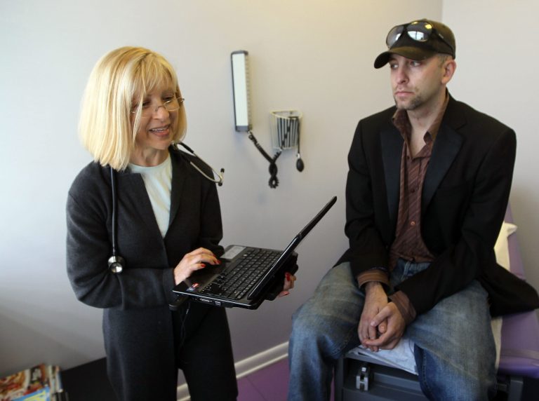 Dr. Klara Gershman uses a laptop to enter information about her patient, Doniel Adivi, on Feb. 16, 2010 in Miami Beach, Florida. (Photo by Joe Raedle/Getty Images)