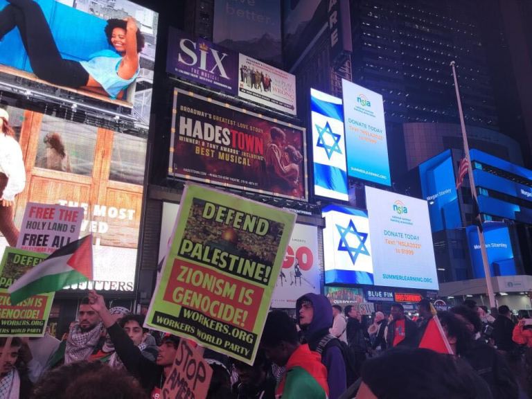 Pro-Palestinian protesters voice their opposition to Israel amid a backdrop of Israeli flags on billboards in Times Square.