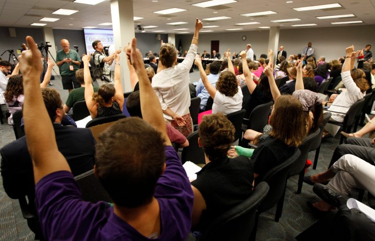   Protesters signal their approval of comments during the public comment portion of a State Board of Health meeting in Richmond, Va., Friday, June 15, 2012. The board is set to vote on permanent abortion clinic regulations. (AP Photo/Steve Helber)  