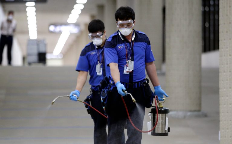 Workers wearing masks and goggles, spray disinfectant as a precaution against the spread of Middle East Respiratory Syndrome virus at Gimpo International Airport in Seoul, South Korea. (AP Photo/Lee Jin-man)