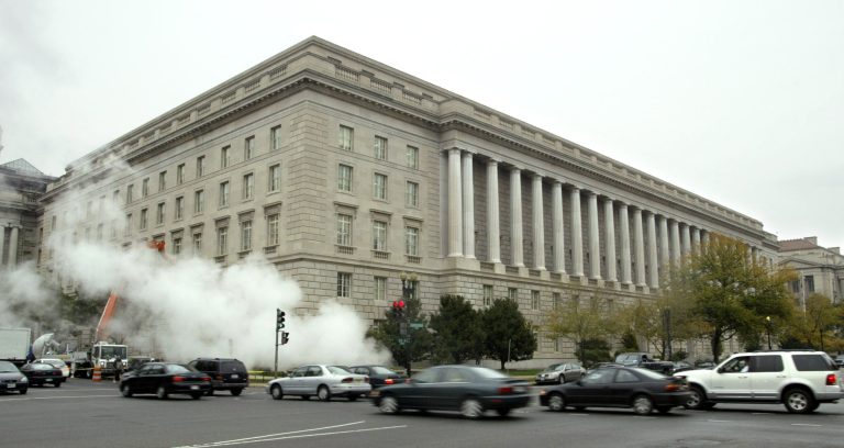 Matthew Cavanaugh/Getty Images
Steam rises from a grate outside the Internal Revenue Service headquarters building in Washington.