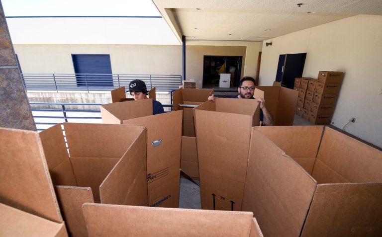 Movers sorts boxes. A Virginia moving company 10 miles from the West Virginia border has been the plaintiff in a federal constitutional lawsuit for roughly a year because, until recently, it needed the permission of West Virginia moving companies to operate within that state. (AP Photo/Denis Poroy)