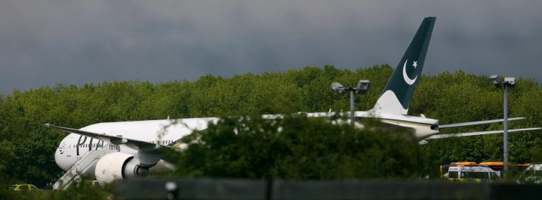 Passengers disembark from Pakistan International Airlines flight PK709 bound for Manchester from Lahore, Pakistan, after it was diverted and landed at Stansted Airport, north of London, England, Friday May 24, 2013. The passenger plane was diverted following an incident on board, and two men were arrested on suspicion of endangerment of an aircraft after an RAF Typhoon jet was scrambled to escort the passenger plane traveling from Pakistan to the UK, police said. (AP Photo / Chris Radburn, PA) UNITED KINGDOM OUT - NO SALES - NO ARCHIVES