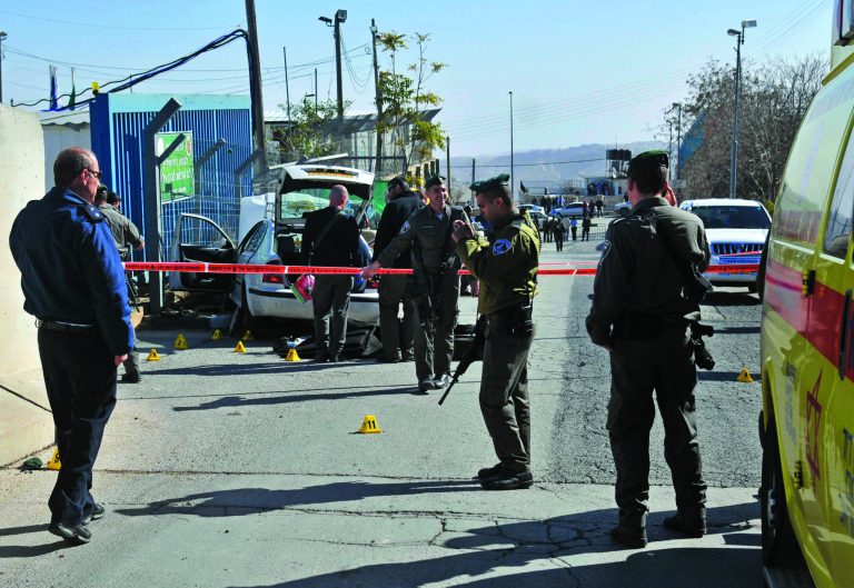 Israeli police cordon off the area next to the site of an attempted attack outside a police station in Jabel Mukaber, in east Jerusalem, Sunday, Dec. 23, 2012. According to Israeli police spokesman and Palestinian sources an Arab taxi driver tried to drive into the police station and was prevented by border policemen who fired shots to stop the vehicle. Both the driver and a police officer were lightly injured in the incident. (AP Photo/Mahmoud Ilean)