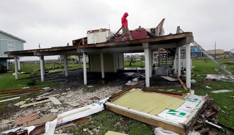 Evelyn Perkins inspects her home, which was destroyed in the wake of Hurricane Harvey, Monday, Aug. 28, 2017, in Rockport, Texas. (AP Photo/Eric Gay)