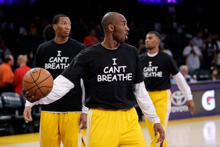 Los Angeles Lakers' Kobe Bryant, center, and his teammates warm up before an NBA basketball game against the Sacramento Kings, Tuesday, Dec. 9, 2014, in Los Angeles. (AP Photo/Jae C. Hong)
