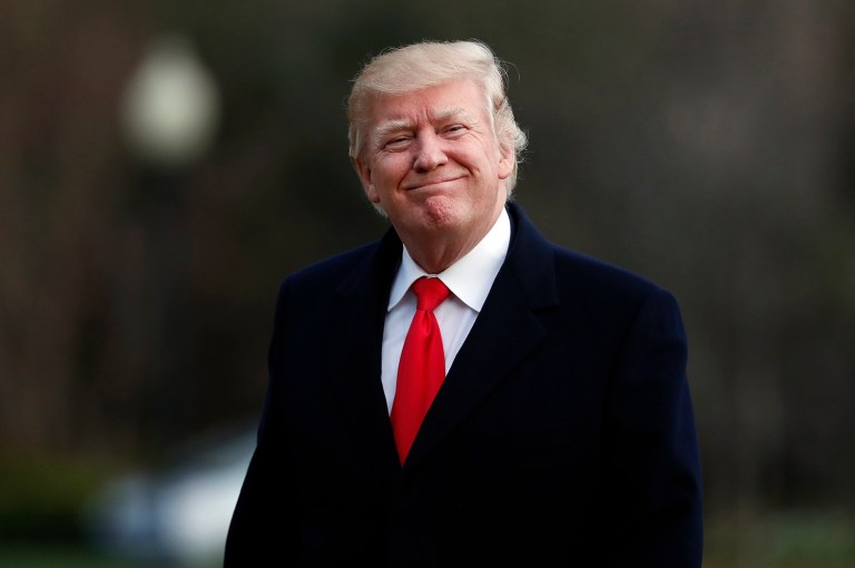 President Trump cheered a Fox News report that said high-ranking intelligence officials released the identity of Trump's associates for political purposes. (AP Photo/Alex Brandon)