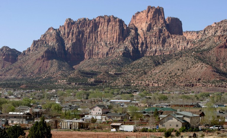 FILE - In this April 20, 2006, file photo, Hildale, Utah, sits at the base of Red Rock Cliff mountains with its sister city, Colorado City, Ariz., in the foreground. Utah's liquor commission has approved a winemaking license for a new winery in the town of Hildale, home to a polygamous sect. (AP Photo/Douglas C. Pizac, File)