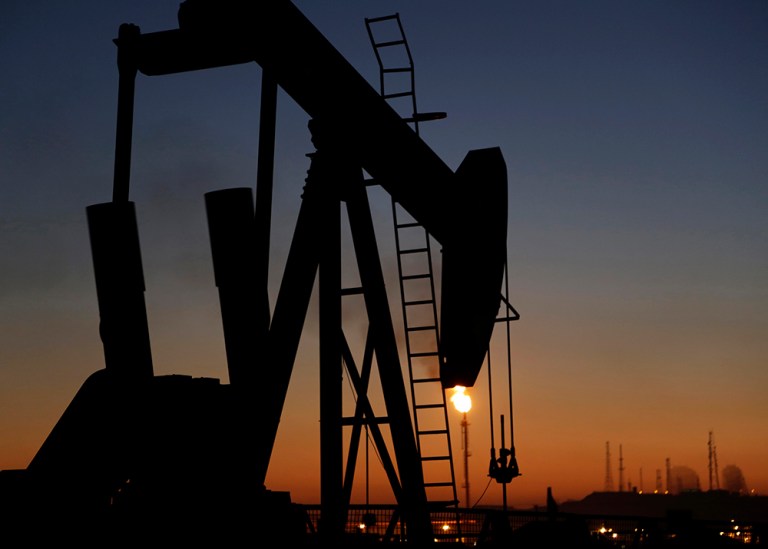 An oil pump works at sunset Monday, Jan. 18, 2016, in the desert oil fields of Sakhir, Bahrain. (AP Photo/Hasan Jamali)