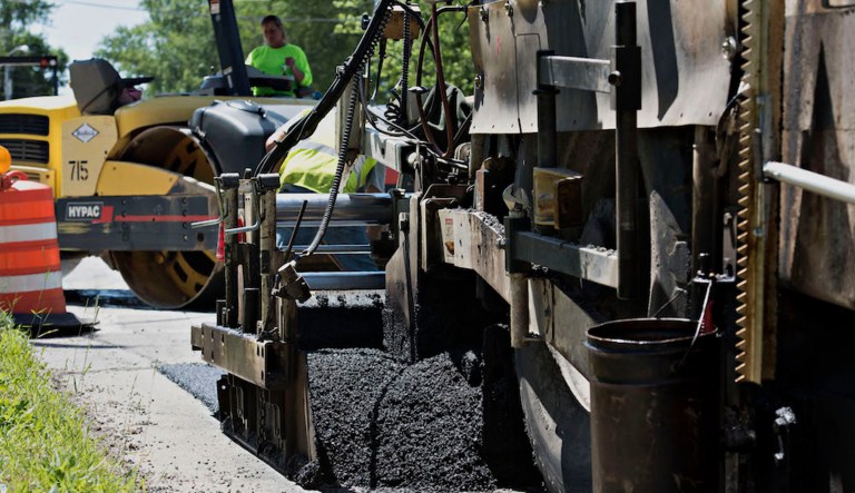 Asphalt piles up in front of a paver machine during operations on an Illinois state highway in Streator, Ill. Momentum for such projects is likely to increase under President Trump's infrastructure plan, says Martin Marietta Materials CEO Ward Nye. (Daniel Acker/Bloomberg)