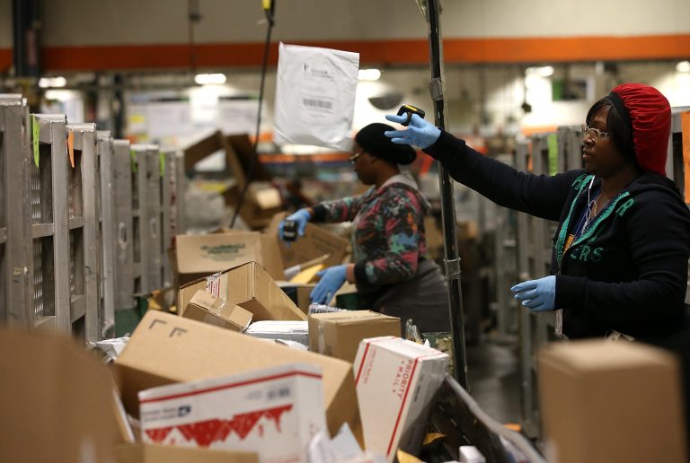 U.S. Postal workers sort packages at the U.S. Post Office sort center on December 18, 2014 in San Francisco, California. (Photo by Justin Sullivan/Getty Images)