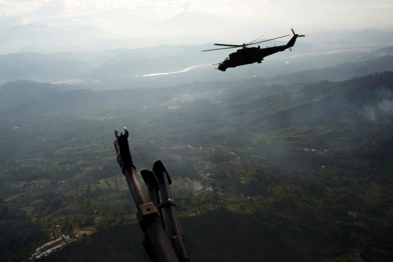 In this Sept. 19, 2014 photo, a military helicopter flies over the VRAEM region, in Pichari, Peru. The region in the Apurimac, Ene and Mantaro River Valleys, or VRAEM, is the world's No. 1 coca-growing region. Security forces destroyed in the last two weeks more than 50 clandestine airstrips used by drug traffickers in the biggest offensive that seeks to combat the intense drug airlift to Bolivia. (AP Photo/Rodrigo Abd)