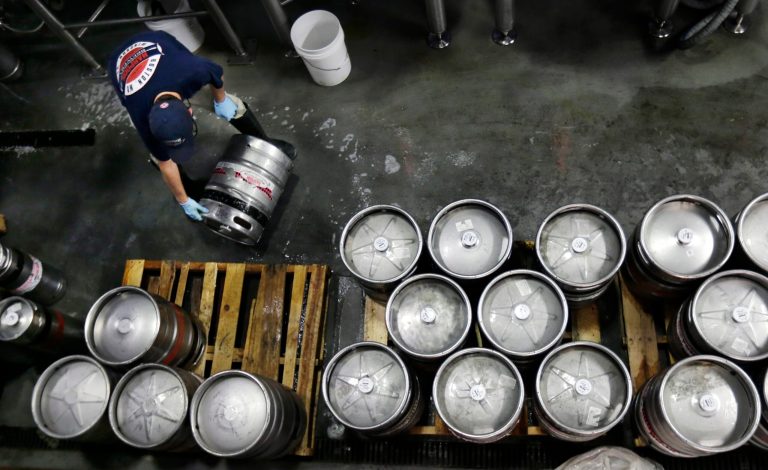   FILE - In this July 1, 2013 file photo, brewer Ken Hermann rolls a fresh keg of beer onto pallets at the Harpoon Brewery in the Seaport District of Boston. The Commerce Department reports on orders placed with U.S. factories in June on Friday, Aug. 2, 2013. (AP Photo/Charles Krupa, File)  