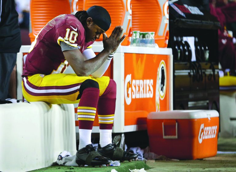 Evan Vucci/Getty Images
Robert Griffin III seemed to hurt his knee again in the first quarter, then was knocked from the game in the fourth Sunday.