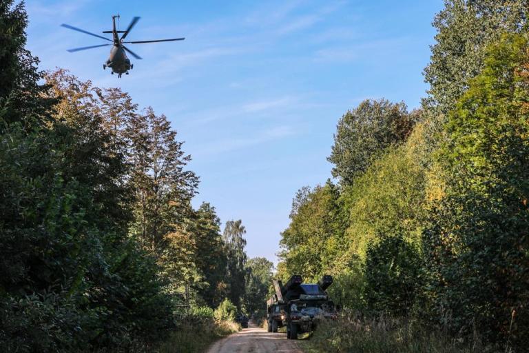 A Soviet-era Mi-8 helicopter flies over an American Patriot missile system as part of the September Tobruq Legacy air-defense exercises in Lithuania. Lithuania, a NATO ally, will replace its aging, Russian-made helicopters with four HC-60 Black Hawk helicopters worth $243 million.