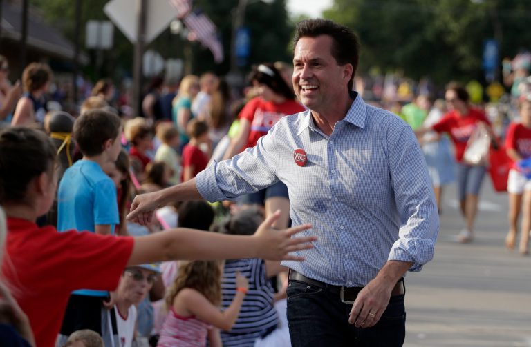 U.S Senate candidate Milton Wolf works the crowd at a Fourth of July parade in Wamego, Kan., in this file photo taken July 4, 2014. (AP Photo/Charlie Riedel, File)