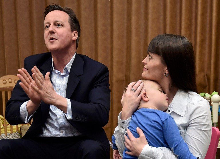 Britain's Prime Minister and Conservative Party leader David Cameron speaks with parents at a nursery during an election campaign visit to Cannock, central England, Wednesday, May 6, 2015. (AP Photo)Â 
