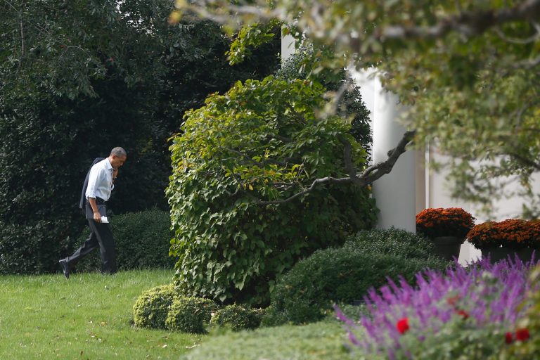President Barack Obama walks back to the Oval Office after he visited Martha's Table, which assists the poor and where furloughed federal employees are volunteering, in Washington, Monday, Oct. 14, 2013. Speaking there Obama said that if Republicans can't resolve the standoff over the debt ceiling and the partial government shutdown, quote, 