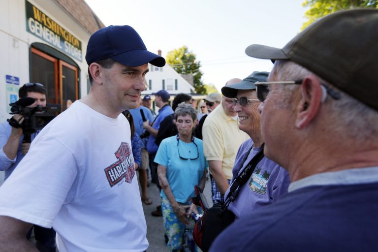 Republican presidential candidate Gov. Scott Walker meets local residents during a stop in Washington, N.H. (AP Photo/Jim Cole)