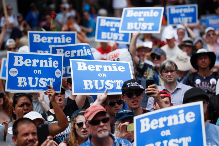 Supporters of Sen. Bernie Sanders, I-Vt., listen during a rally near City Hall in Philadelphia during the second day of the Democratic National Convention. (AP Photo/John Minchillo)