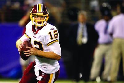 Quarterback John Beck #12 of the Washington Redskins looks to pass against the Baltimore Ravens during the second half of a preseason game at M&T Bank Stadium on August 25, 2011 in Baltimore, Maryland.