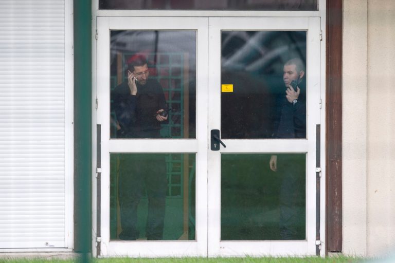 Police officers communicate inside a school of Dammartin-en-Goele, northeast of Paris, Friday Jan. 9, 2015. Brothers suspected in a newspaper terror attack were cornered with a hostage inside a printing house on Friday, after they hijacked a car and police followed them to a village near Paris' main airport. (AP Photo/Peter Dejong)