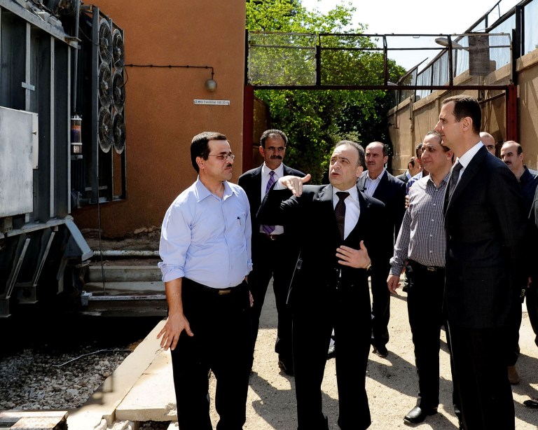 In this photo released by the Syrian official news agency SANA, President Bashar Assad, right, visits the Umayyad Electrical Station on May Day, a day after a powerful bomb hit the capital. in Damascus, Syria, Wednesday, May 1, 2013. (AP Photo/SANA)