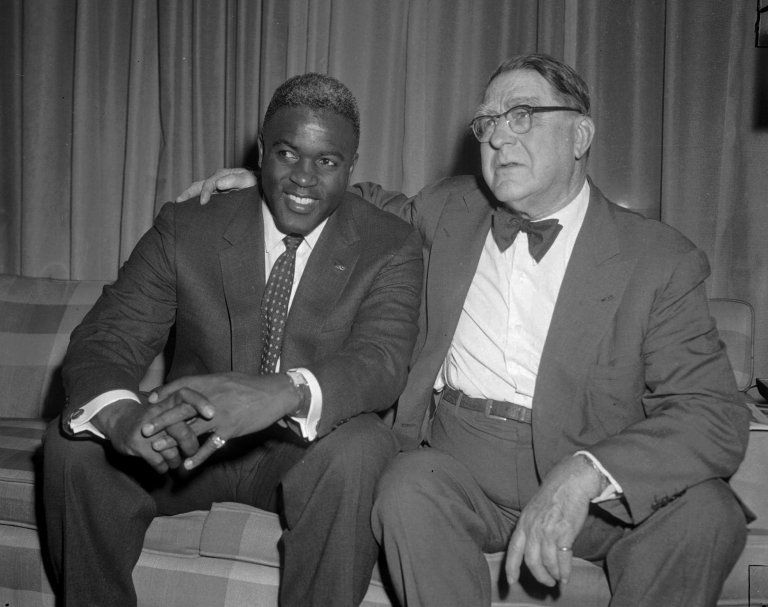 Jackie Robinson, the first black to play major league baseball, chats Jan. 21, 1957 with Branch Rickey Sr., who as general manager of the Brooklyn Dodgers signed Robinson to his major league contract. Both men are retired from baseball. They met in Pittsburgh when Robinson visited the city to campaign for funds for the NAACP. (AP Photo)
