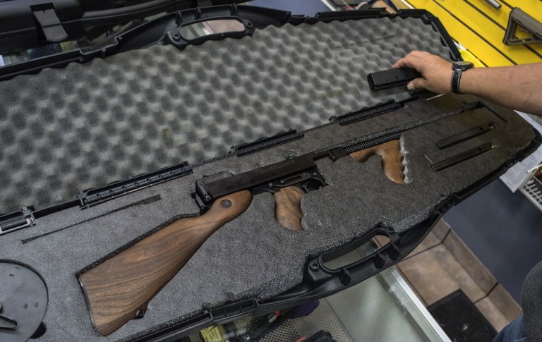 A Thompson submachine gun, better known as a "Tommy gun," is displayed at a New Mexico gun store. A wide swath of U.S. companies are reconsidering their relationship with the firearms industry after a high-school shooting spree that killed 17 people. 