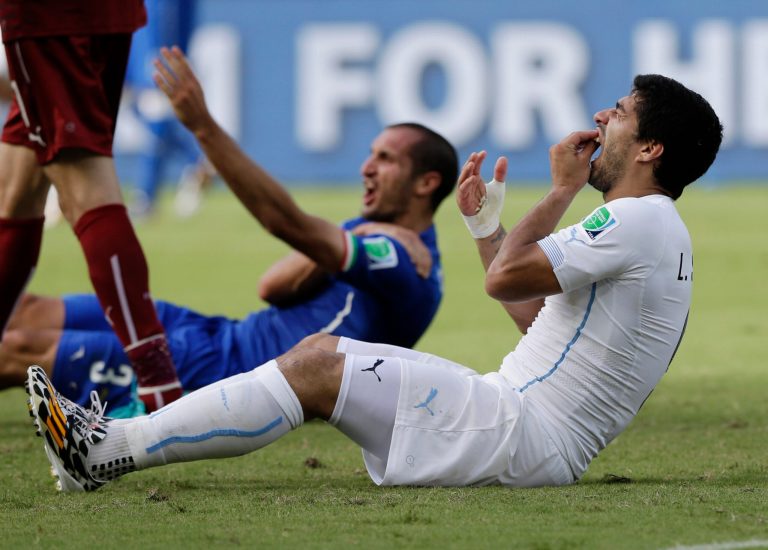 FILE - In this June 24, 2014 file photo, Uruguay's Luis Suarez holds his teeth after running into Italy's Giorgio Chiellini's shoulder during the group D World Cup soccer match between Italy and Uruguay at the Arena das Dunas in Natal, Brazil. Suarez was banned for nine competitive international matches, four months from all football and fined for biting Chiellini's shoulder during the group D World Cup soccer match. Football's international governing body on Thursday, July 10, 2014, said its appeals committee rejected Suarez's appeal against his ban for biting his opponent. (AP Photo/Ricardo Mazalan, File)