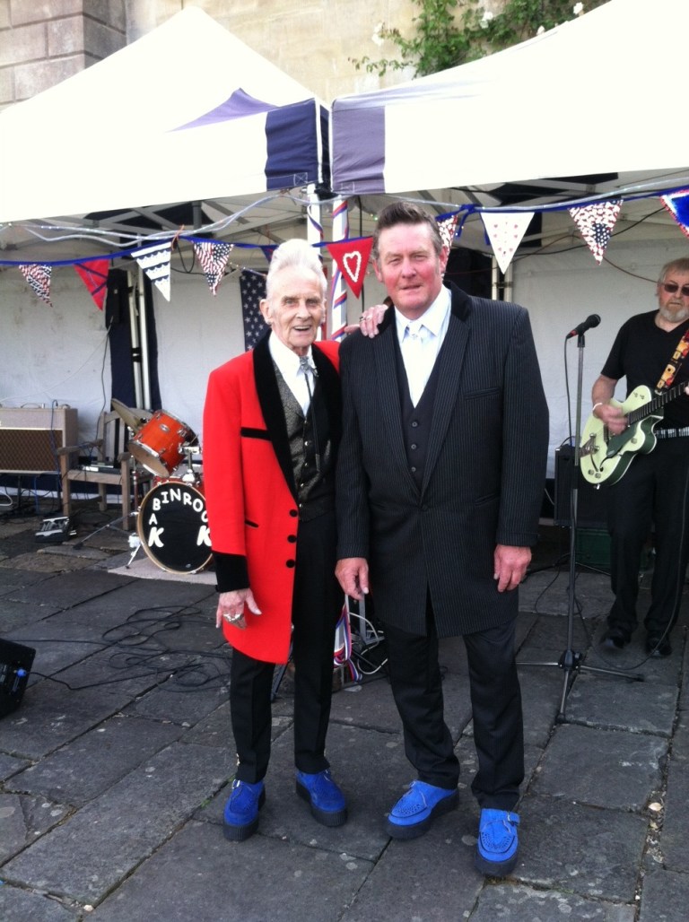 Brits Mark Sawyer, left, and John Bryant, both of Bath, England, are seen in front of the Elvis band at the 2013 Fourth of July celebration wearing their blue suede shoes. Bath is home of the American Museum of Britain, which houses the largest collection of Americana outside of the U.S. (Photo by Richard Pollock)