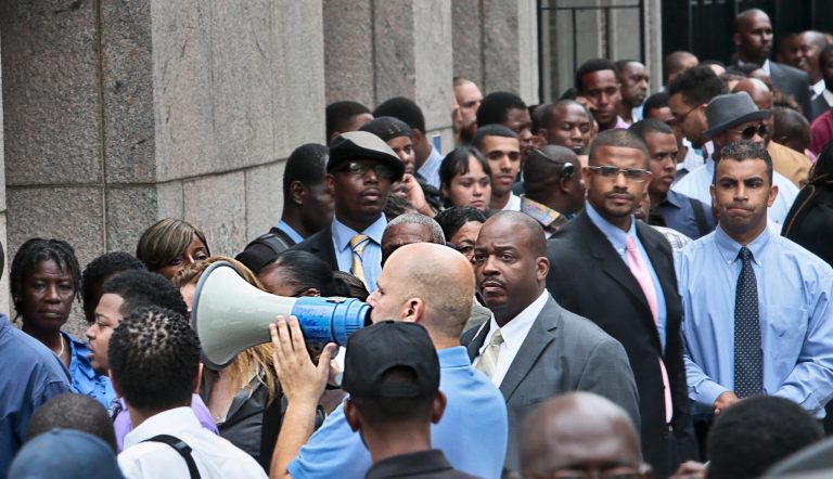 FILE - In this  Thursday, Aug. 8, 2013, file photo, Applicants listen to a speaker's bull horn instructions for attending a combined Metropolitan Transportation Authority (MTA) and Harlem Week job and career fair at Columbia University in New York. The Labor Department reports the number of people who applied for unemployment benefits last week later Thursday May 29, 2014. (AP Photo/Bebeto Matthews, File)