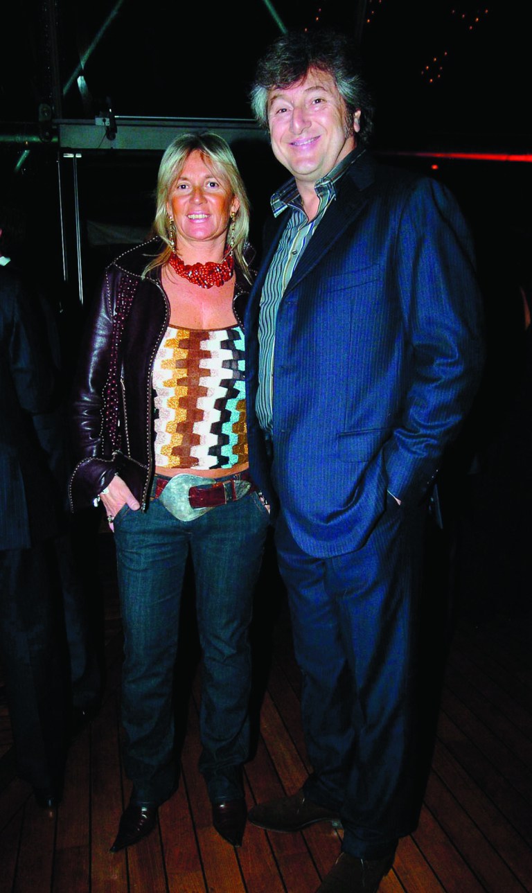 In this photo taken on March 30, 2005 Vittorio Missoni, right, and his wife Maurizia Castiglioni smile in Milan, Italy. The search resumed Saturday, Jan. 5, 2013 for a small plane that has disappeared off the Venezuelan coast with six people aboard, including Vittorio Missoni, a top executive in Italy's Missoni fashion house, officials said. Vittorio Missoni, 58, is the director general of the iconic brand and the eldest son of the company's founder. Flying with him on Friday's flight from Venezuela's Los Roques resort archipelago to Caracas, was Missoni's wife, Maurizia Castiglioni, two Italian friends of the couple, and a crew of two Venezuelans. (AP Photo/Livio Valerio, Lapresse)