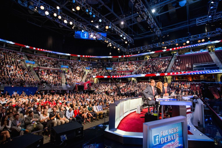 Fox News moderators from left, Chris Wallace, Megyn Kelly and Bret Baier speak to the camera before Republican presidential candidates New Jersey Gov. Chris Christie, Sen. Marco Rubio, R-Fla., Ben Carson, Wisconsin Gov. Scott Walker, Donald Trump, former Florida Gov. Jeb Bush, former Arkansas Gov. Mike Huckabee, Sen. Ted Cruz, R-Texas, Sen. Rand Paul, R-Ky., and Ohio Gov. (AP Photo/Andrew Harnik)