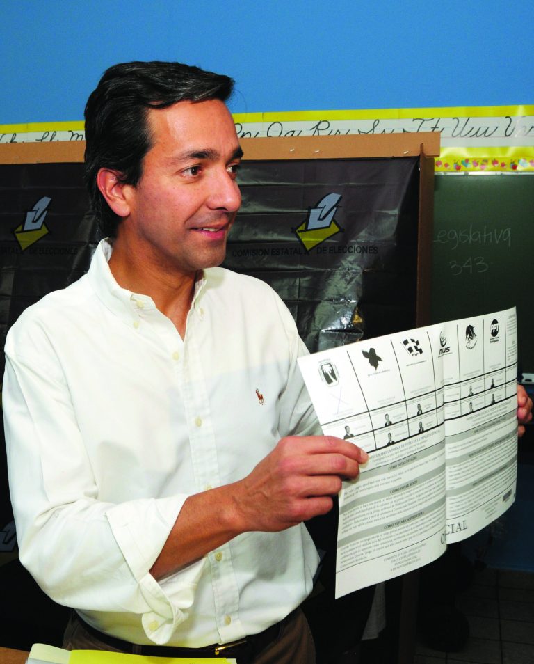 In this image released by the New Progressive Party, Puerto Rico's Gov. Luis Fortuno shows his ballot to the press as he votes at a polling station in Guaynabo, Puerto Rico, Tuesday, Nov. 6, 2012. Puerto Ricans are electing a governor as the U.S. island territory does not get a vote in the U.S. presidential election. But they are also casting ballots in a referendum that asks voters if they want to change the relationship to the United States. A second question gives voters three alternatives: become the 51st U.S. state, independence, or 