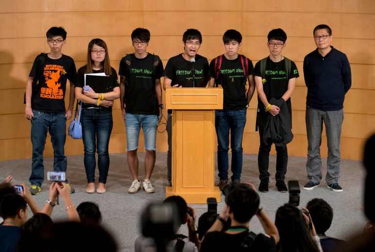 Student leader Alex Chow, center, speaks along with other leaders, during a news conference after the talks with the Hong Kong government officials, in Hong Kong Tuesday, Oct. 21, 2014. Hong Kong student leaders and government officials held talks Tuesday to end pro-democracy protests now in their fourth week even as the city's Beijing-backed leader reaffirmed his unwillingness to compromise on the activists' key demand. Other leaders are from left to right,  Joshua Wong, Yvonne Leung, Eason Chung, Lester Shum, Nathan Law, and the founder of the Occupy Central civil disobedience movement Chan Kin-man. (AP Photo/Kin Cheung)