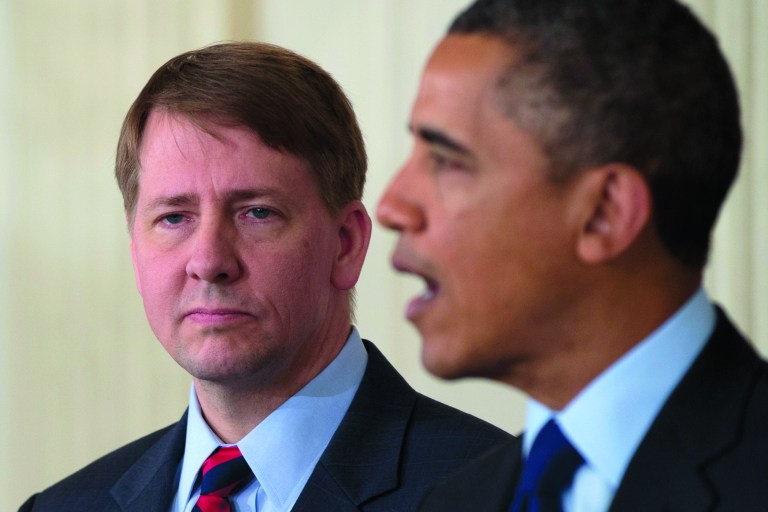 Richard Cordray stands left as President Barack Obama announces in the State Dining Room of the White House in Washington, Thursday, Jan. 24, 2013, that he will re-nominate Cordray to lead the Consumer Financial Protection Bureau, a role that he has held for the last year under a recess appointment, and nominate Mary Joe White to lead the Security and Exchange Commission (SEC). (AP Photo/Carolyn Kaster)