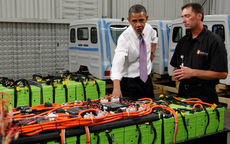 President Barack Obama listens to Dennis Hartman as they look at rechargeable car batteries during his tour of Smith Electric Vehicles in Kansas City, Mo, Thursday, July 8, 2010. (AP Photo/Pablo Martinez Monsivais)