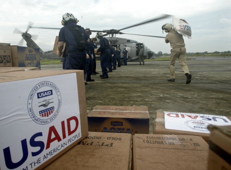US Navy personnel from the carrier USS Abraham Lincoln, load rice and other food supplies onto a U.S. Navy helicopter at Banda Aceh airport for a sortie to earthquake-tsunami victims, January 4, 2005, in northwest Indonesia. (AP File)