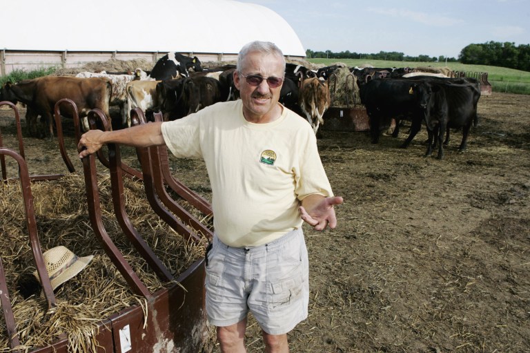 FILE - This May 31, 2006 file photo shows Dave Minar, who with his wife and family own Cedar Summit Farm near New Prague, Minn. The small organic dairy has prevailed in its legal effort to force a buyout by a utility building high-voltage power lines along the property. The case involving Cedar Summit was seen as an early test of Minnesota's revised 