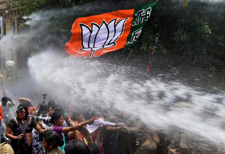 Women activists of Bharatiya Janata Party, flag seen top, face police water cannons as they demonstrate outside the office of Uttar Pradesh state chief minister Akhilesh Yadav, demanding that he crack down on an increasing number of rape and other attacks on women and girls, in Lucknow, India, Monday, June 2, 2014. Police used water cannons to disperse hundreds of women who were protesting Monday against a rise in violence against women in the northern Indian state where two teenagers were gang-raped last week and later found hanging from a tree. (AP Photo)